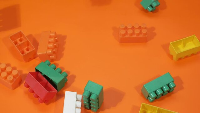 Blocks fall from the top to the orange background. Slow motion.