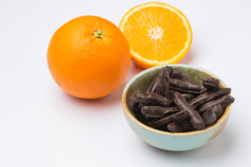 Orange in chocolate on a white background