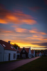 beautiful sky at sunset with houses in the foreground
