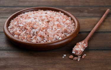 Himalayan pink salt on wooden plate and spoon