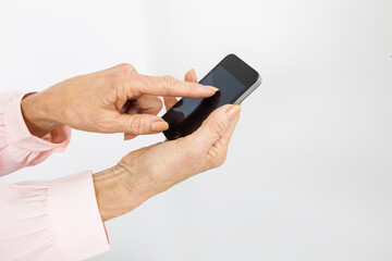 Cropped image of senior businesswoman using smart phone in office