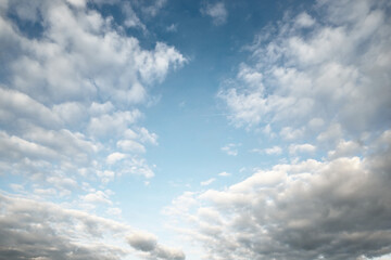 Dramatic cloudscape. White ornamental clouds after the rain at sunset. Fickle weather. Abstract...