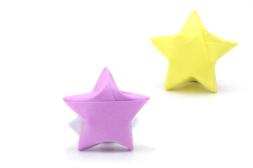 two lucky paper stars on white