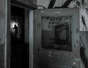 Looking through doorway at artist at working in studio located in derelict abandoned building fire...