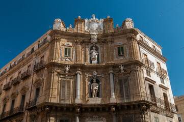 Fototapeta na wymiar Front fasade of building with sculptures and columns in Palermo - Sicily, Italy.