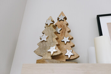 Close up of two wooden Christmas Trees on the shelf