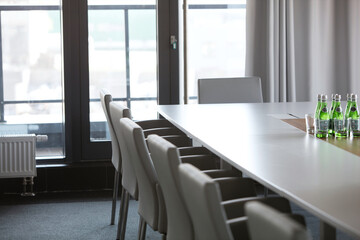 Chairs at conference table in modern office