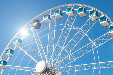 Ferris wheel high against the blue sky