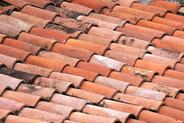 Vintage clay tiled roof. Multi colored old roof tiles background.