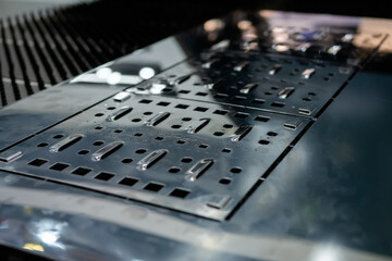 Metal sheet surface with holes of different sizes and forms after hydraulic punching and shearing...