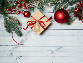 Christmas flatley with a gift and New Year's toys on a light wooden background. new year 2021