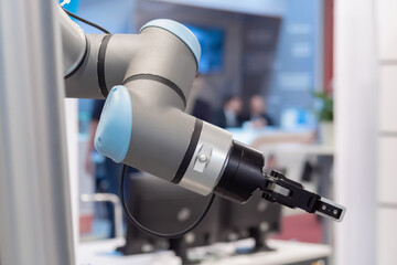 Close up view of moving futuristic robotic clamp arm at robot exhibition. Future, engineering,...