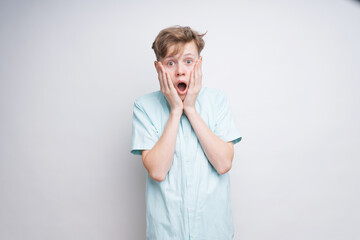 A caucasian boy is surprised. Looking like 