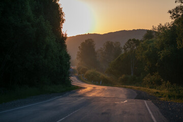 Fototapeta premium Picturesque landscape scene and sunrise above road