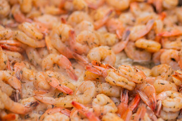 Process of grilling shrimps, prawns on brazier at summer local food market - close up view. Outdoor cooking, gastronomy, seafood, barbecue, street food concept