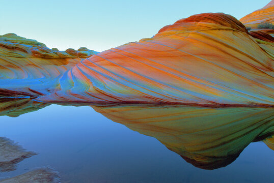 The "WAVE" with Sandstone Prism 4 Phenomenon and Water Reflections.  With rain sandstone absorbs water molecules and along with quartz already in rock, together they bend light like an opal gemstone. 