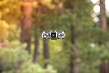 Drone with professional cinema camera flying  in the forests