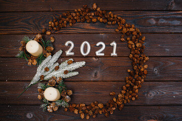 Brown Christmas background in the shape of a circle is decorated with festive Christmas decor and accessories, a garland. Festive new year's card.