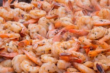 Process of grilling fresh red king prawns on brazier at summer local food market - close up view. Outdoor cooking, gastronomy, seafood, barbecue, street food concept