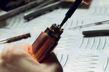 Specialist replaces spring for smoking vape.Professional maintaining electronic cigarette in...