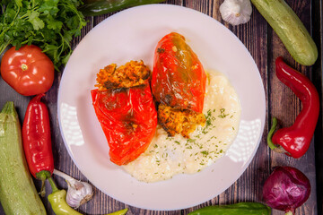 Tasty Stuffed peppers, in a plate on a wooden table