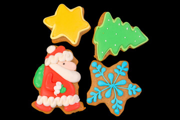 Group of tasty christmas print cookies isolated on black background.