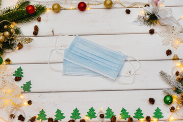 Medical mask on a white Christmas background. Christmas card