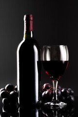 Glass of red wine and bottle