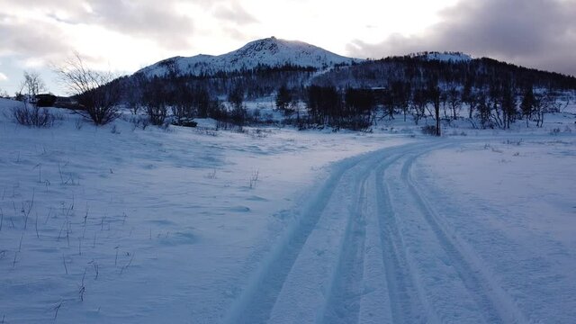 Cross country ski trail with snow covered mountain in the background