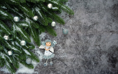 Christmas and New Year holiday background. Silver balls, angel and fir tree on abstract dark background. flat lay. 