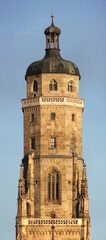 Fototapeta na wymiar Symmetrical view of the gothic St Georg church tower in the old town of Nördlingen, Bavaria in Germany