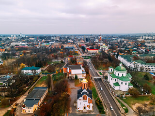 Fototapeta na wymiar Aerial view of roundabout road with circular cars in small european city at autumn cloudy day