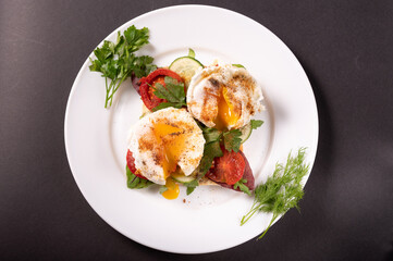 Poached eggs with herbs and vegetables. View from above.