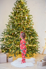 Little girl near Christmas tree