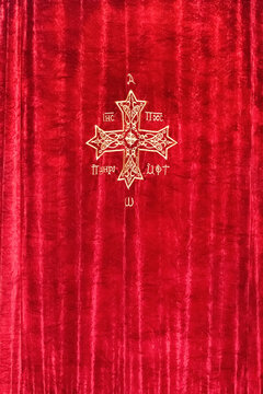 Yellow Cross on a red curtain in a Coptic church. Egypt. Sharm El Sheikh