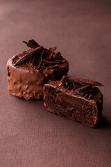 Stack of chocolate brownies chocolate cake on a brown background
