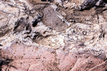 Natural stone background with cracks and scratches texture.