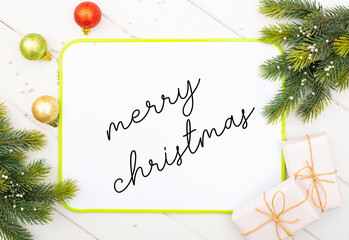 writes merry christmas message on white board with handwriting