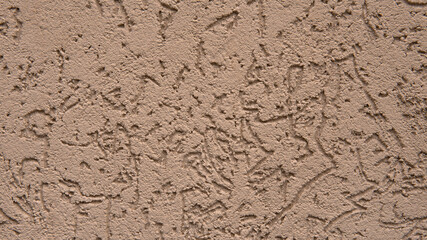 Beautiful light brown texture of concrete wall of the house. Abstract background for a construction project. Decorative textured plaster, outside surface finish at home.