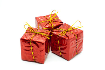 Three similar red gift boxes with with golden bow isolated on white background. Christmas and holidays present concept.