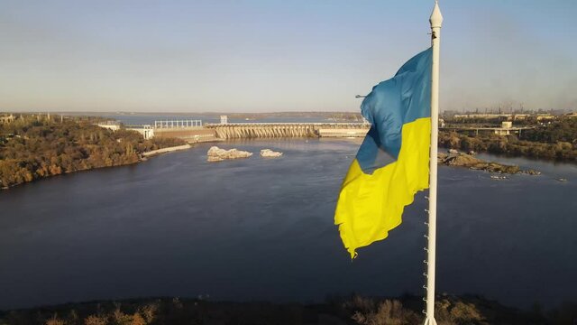 Flag of Ukraine, Zaporozhye drone, Dnipro Hydroelectric Power Plant, dam. Zaporizhia, Ukraine, Zaporozhye from above. The flag waving in the wind.