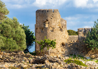 Ruins of the venetian Loutro fortress on hiking path to the rremote esort village of Loutro in the...
