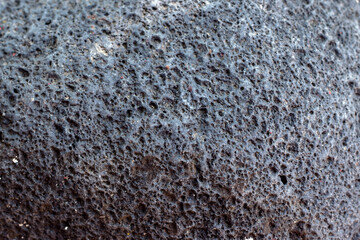 Background of black porous natural stone.