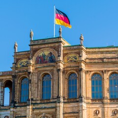 Waving German flag above The Maximilianeum (1874), seat of Bavarian Landtag, Munich, Germany