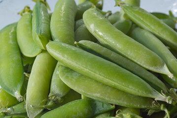 freshly picked peas from the garden are spread out on a plate for cooking
