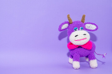 violet smiling cow toy isolated on violent background