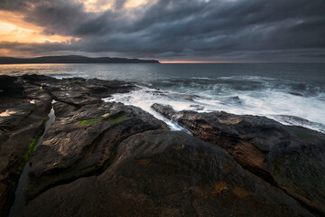 Overcast Sunrise on the rocks between Umina Beach and Pearl Beach on NSW Central Coast