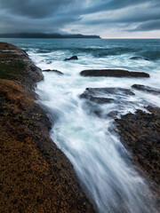Overcast Sunrise on the rocks between Umina Beach and Pearl Beach on NSW Central Coast