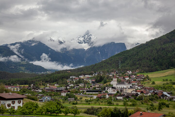 Fototapeta na wymiar A village in the Alps among the mountain peaks.