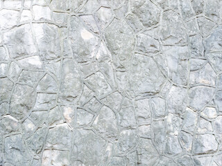 Background gray textured wall with rough patterned masonry. Full screen photo